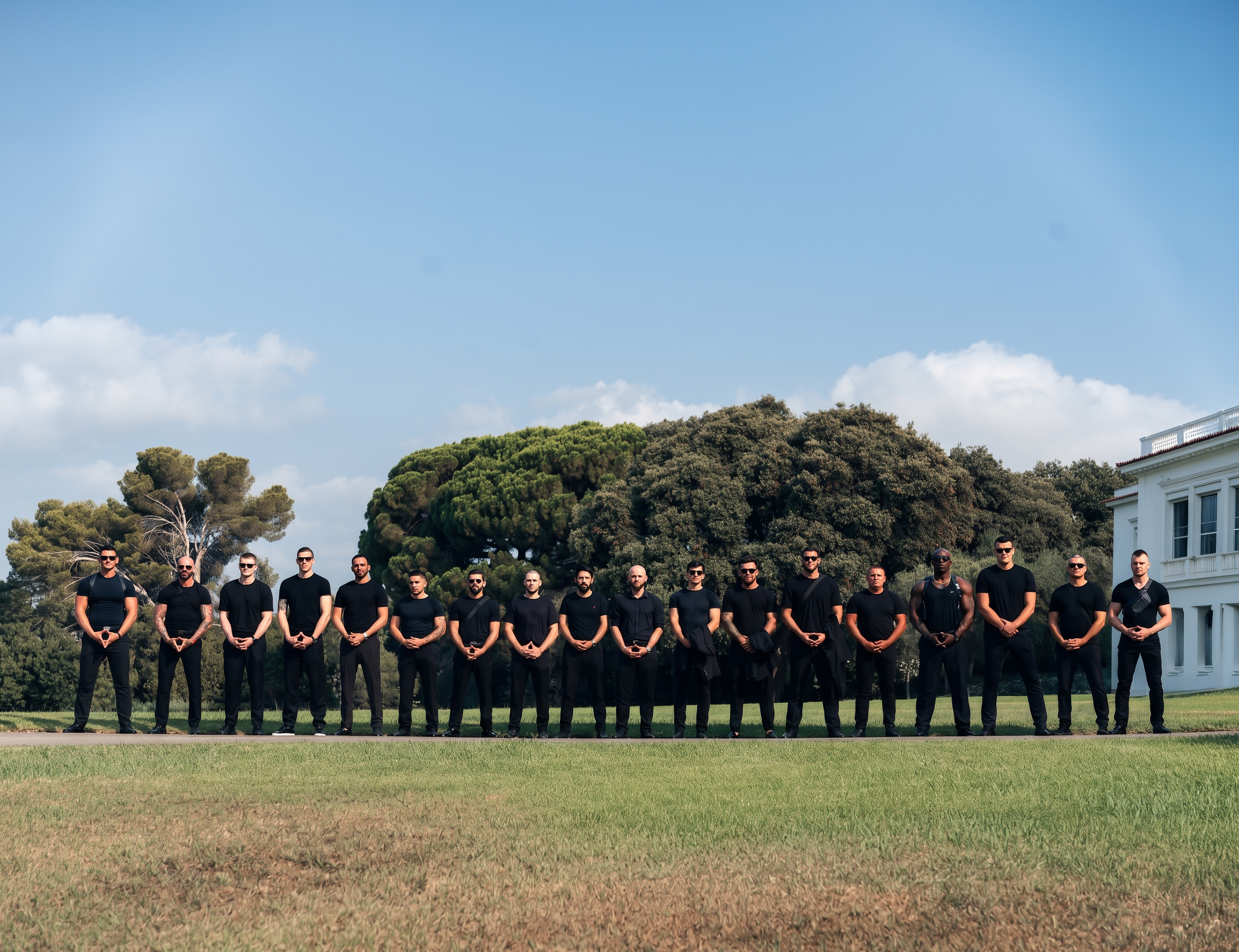 The LEON team of protection officers lined up in front of a villa